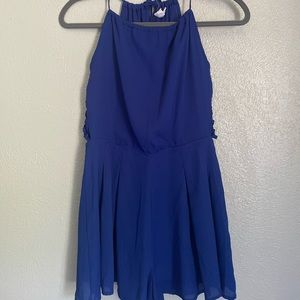 Blue sleeve-less romper with side details & open back